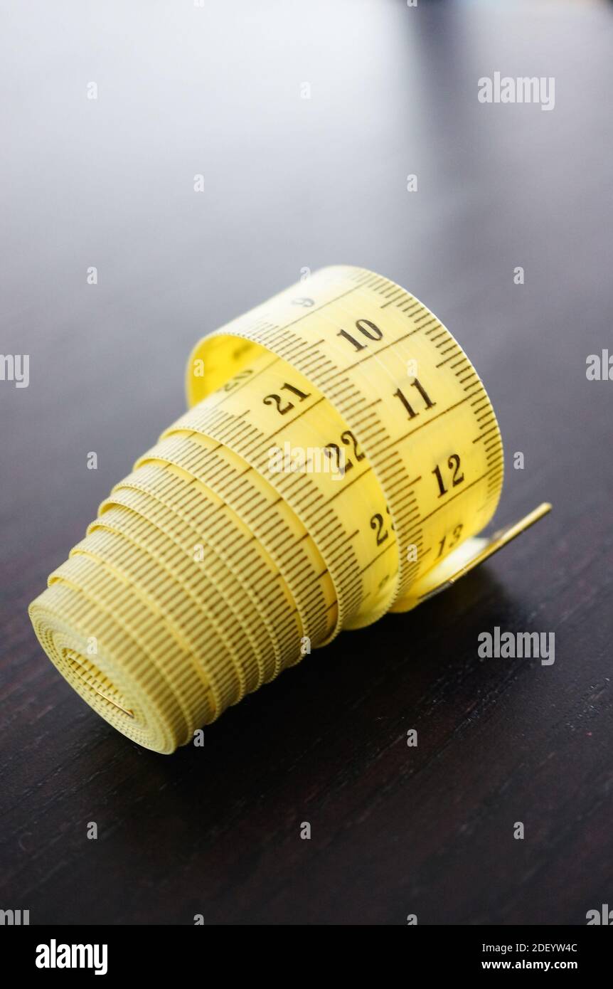 Rolled up red tape measure hi-res stock photography and images - Alamy