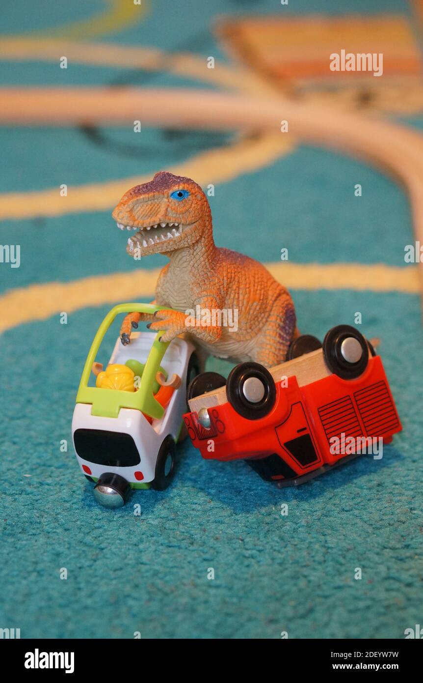 A vertical shot of toy tyrannosaurus rex lifting a car and a truck Stock  Photo - Alamy, image size:862x1390