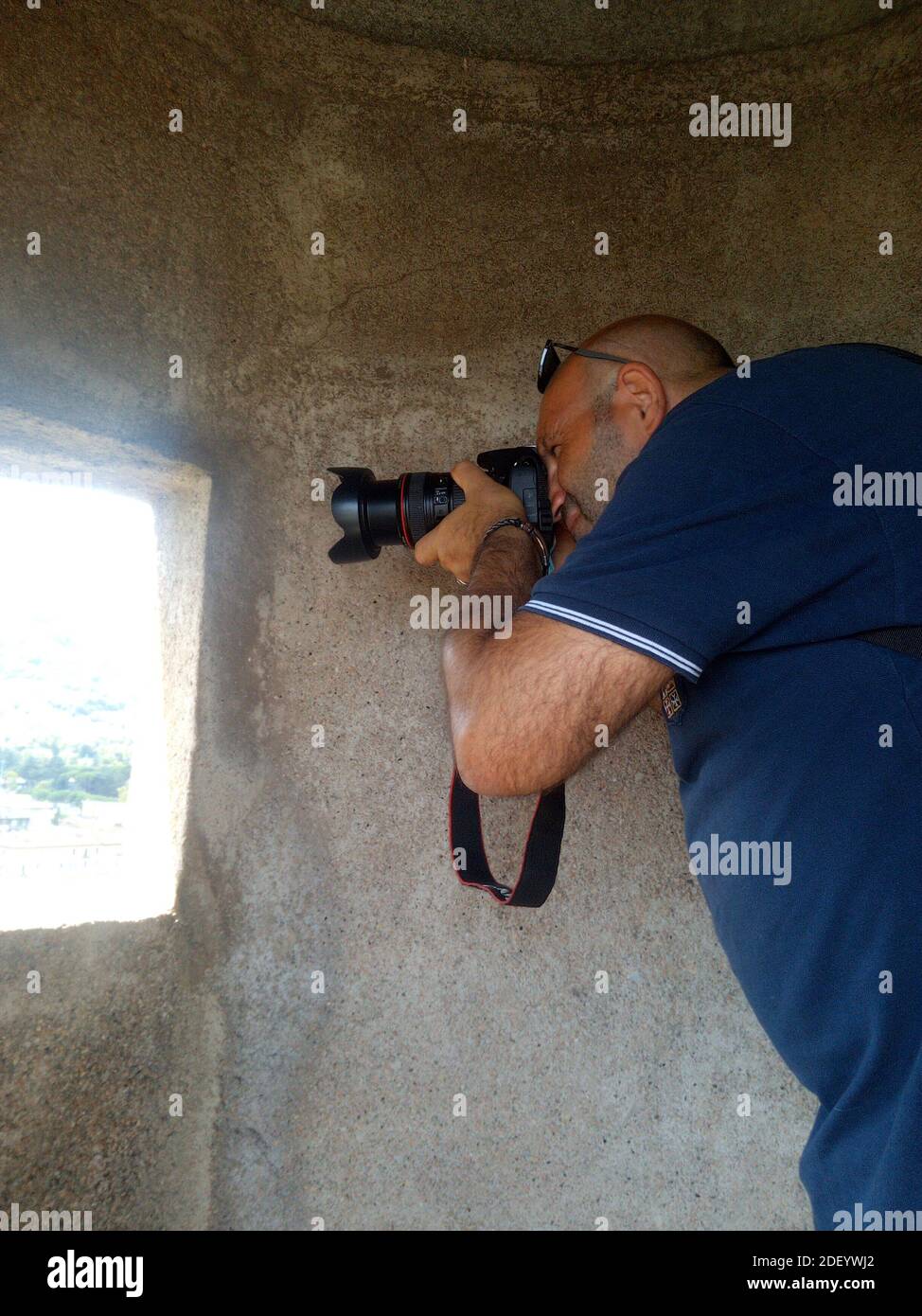 a photographer takes a picture from a window in a ww2 bunker Stock Photo