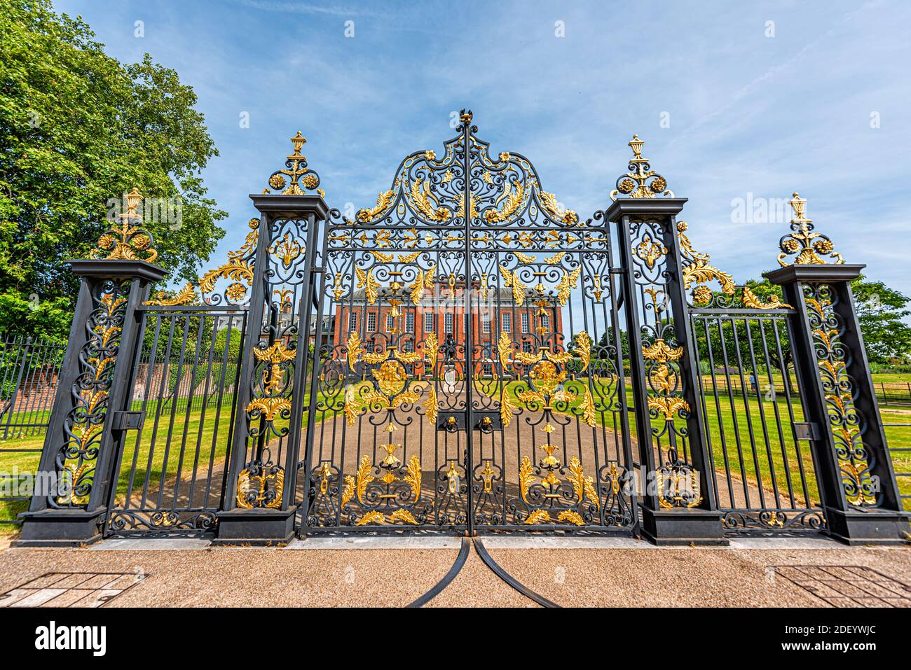London, UK - June 24, 2018: Kensington Palace by gardens in Hyde park with closed bronze cast iron golden gold gate entrance in summer with blue sky i Stock Photo