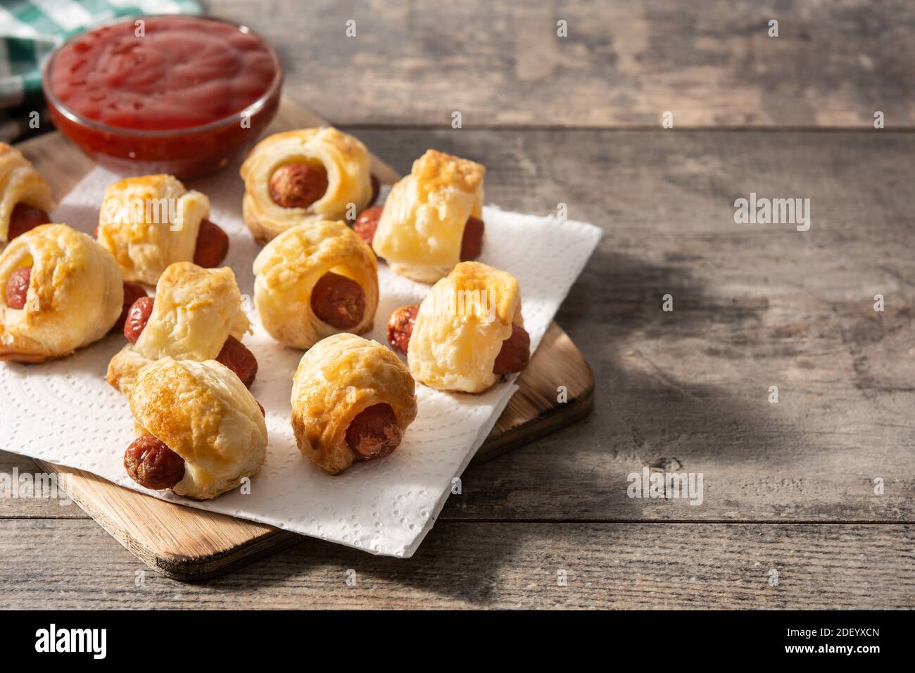 Pigs in blankets. Mini sausages wrapped in puff pastry with ketchup sauce Stock Photo Alamy