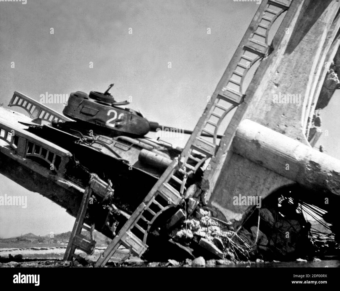 The wreckage of a bridge and North Korean Communist tank south of Suwon, Korea. The tank was caught on a bridge and put out of action by the Air Force, 7 October 1950 Stock Photo