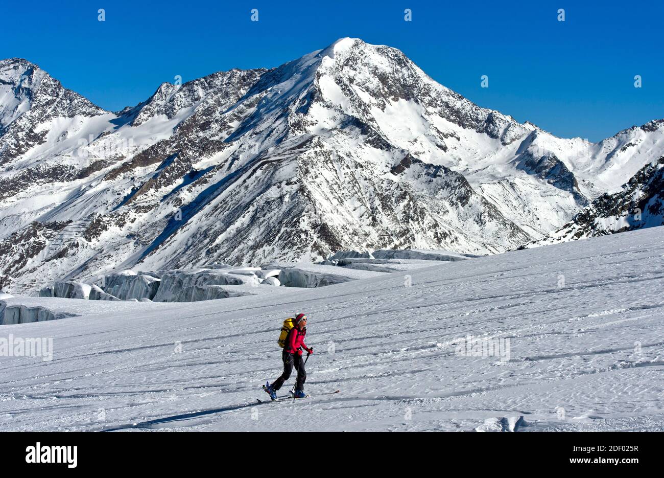Touring skier on the Fee Glacier, Weissmies summit behind, Saas-Fee, Valais, Switzerland Stock Photo