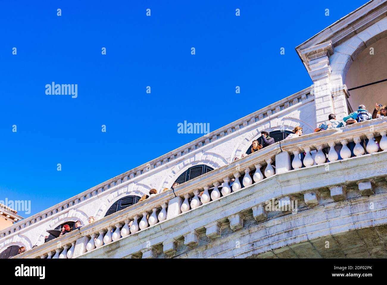 The Rialto Bridge is the oldest of the four bridges spanning the Grand Canal in Venice. Connecting the sestieri, districts, of San Marco and San Polo, Stock Photo