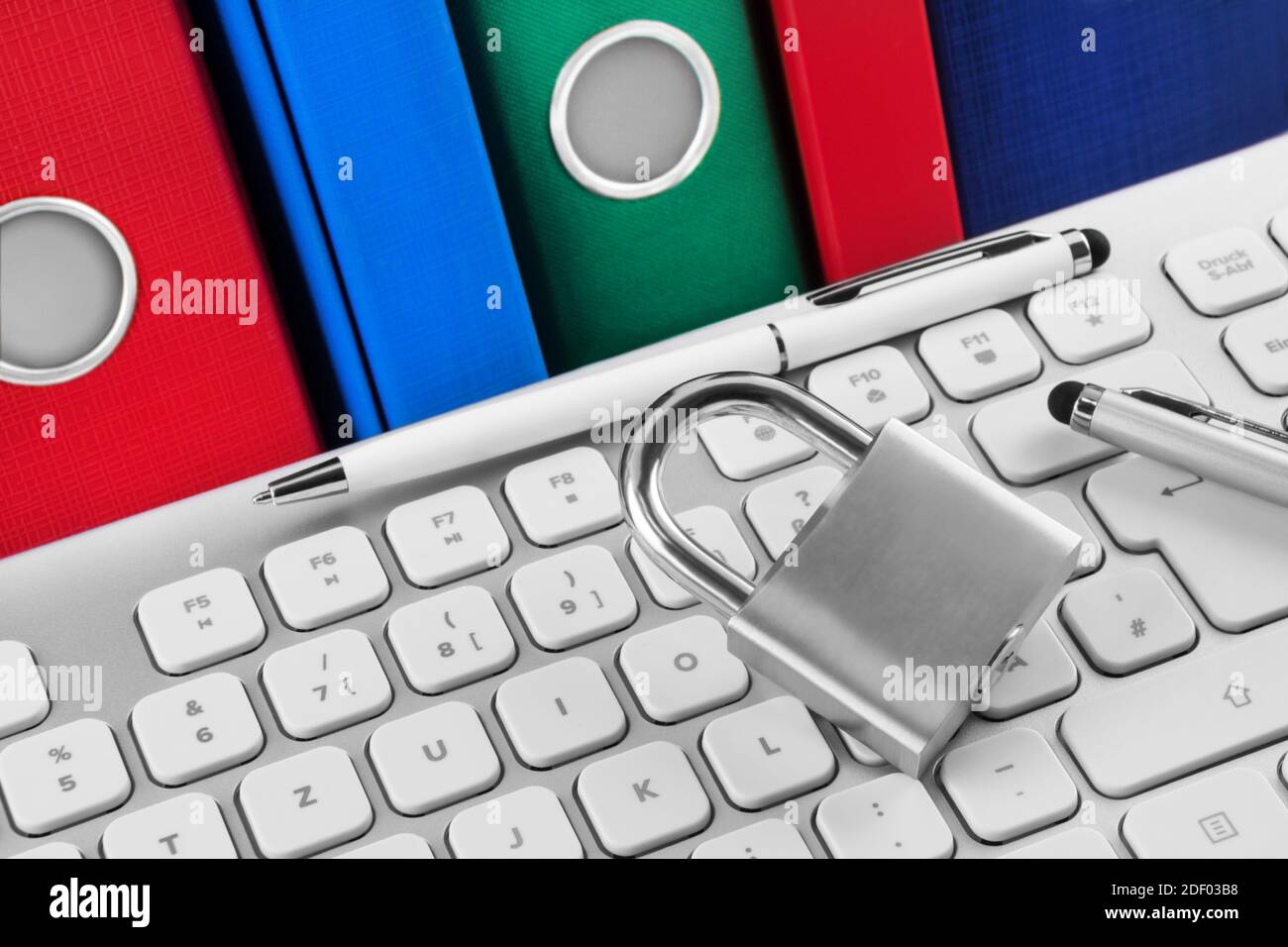 PC keyboard and lock with file folders Stock Photo