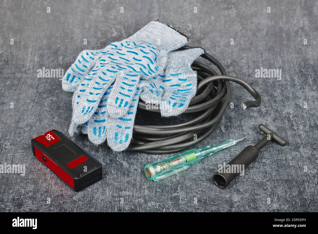 Professional repair tools for the electrician to install and repair electrical equipment in the house on a gray background Stock Photo