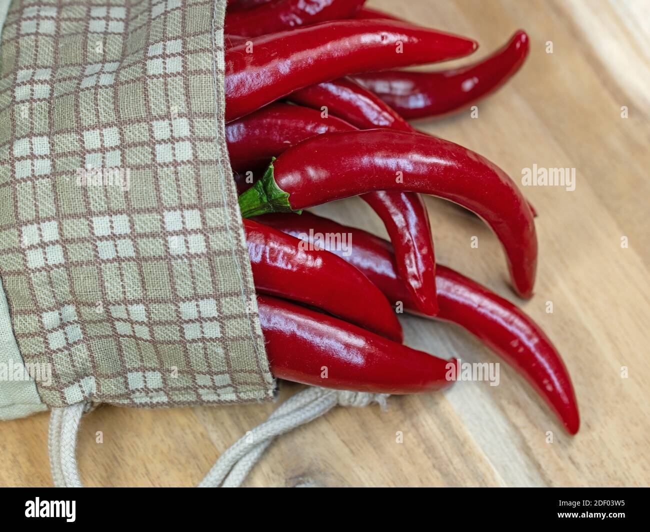 Hot peppers, Capsicum annuum, in a cloth sack Stock Photo