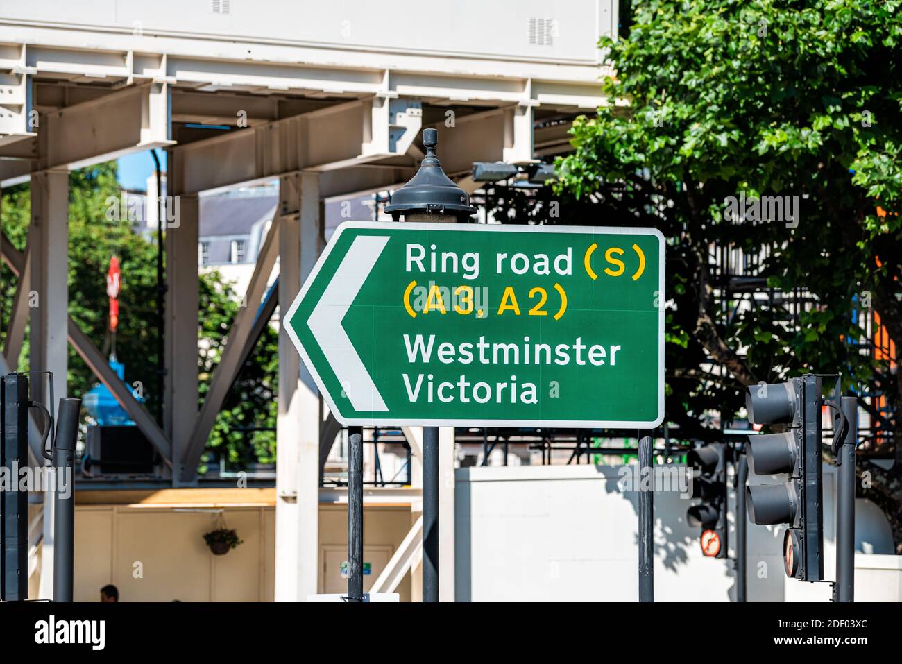 London, UK United Kingdom and green traffic sign directions to Ring road and Westminster Victoria on sunny summer day Stock Photo