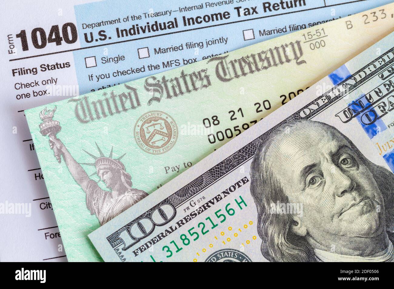 Hundred Dollar Bill with Tax Refund Check and Form 1040. Stock Photo