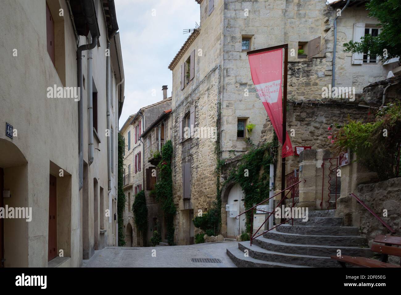 SOMMIERES, FRANCE - OCTOBER 21st, 2020: A typical street in the old town of Sommieres with beautiful old stone houses Stock Photo