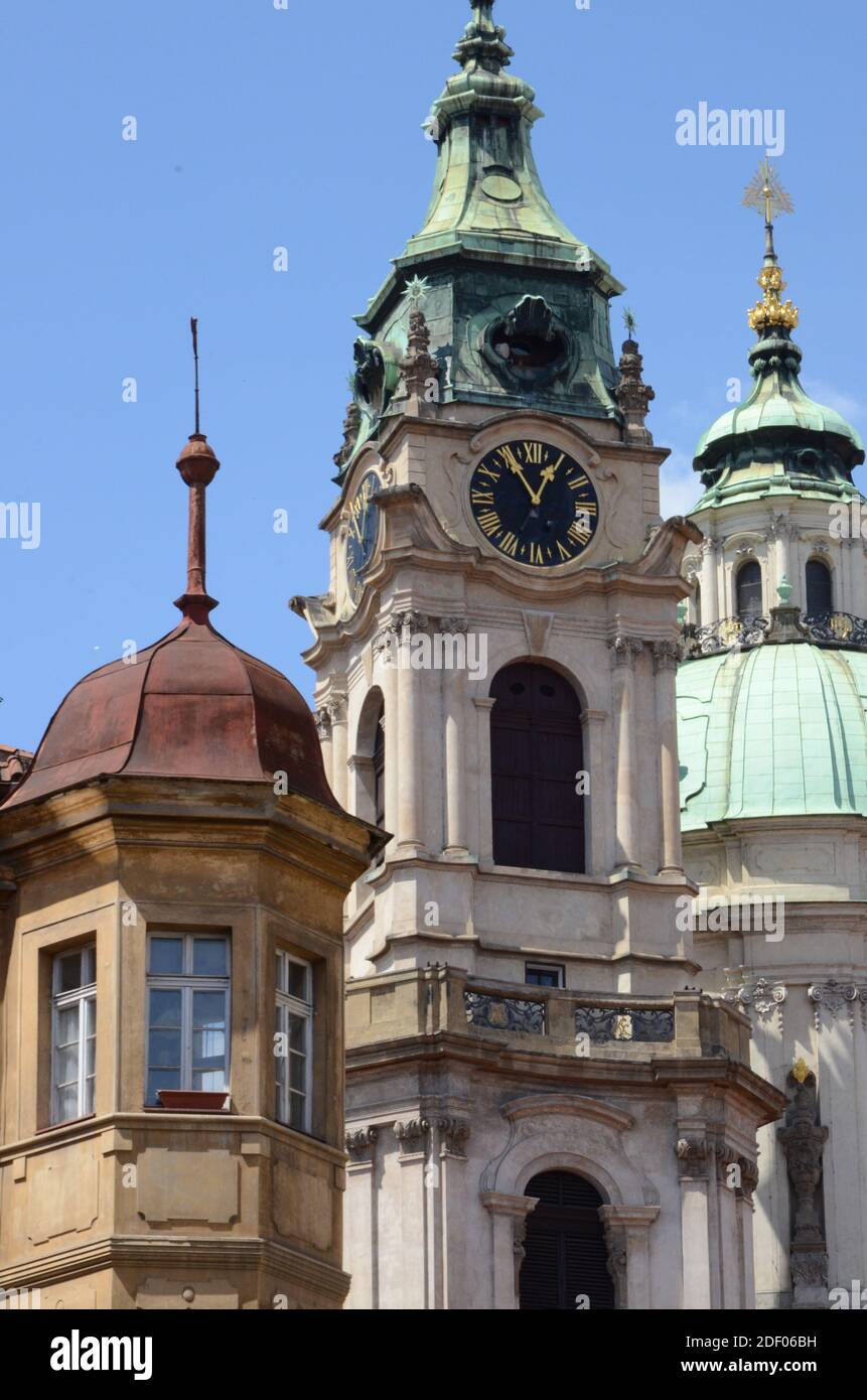 A historical clock in the tower section and tower of a building in recent European architecture Stock Photo