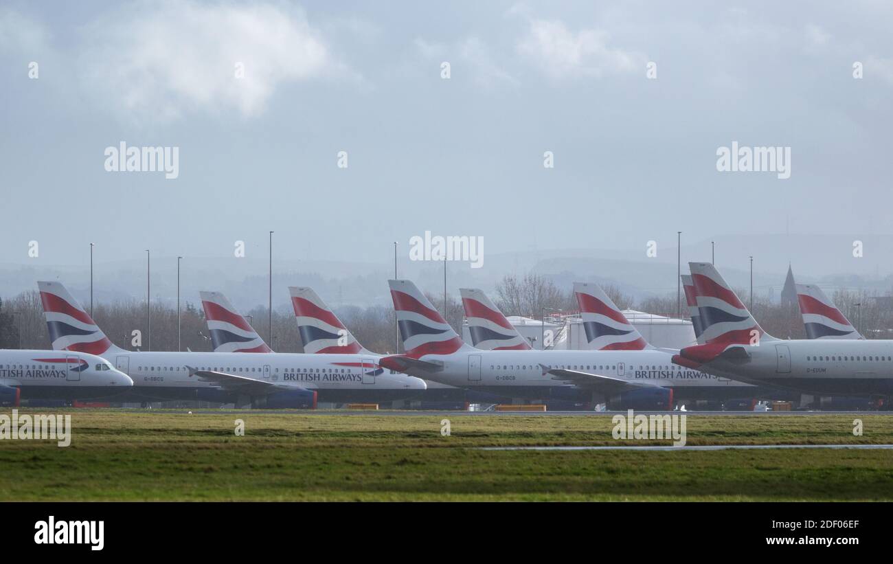 Glasgow, Scotland, UK. 2nd Dec, 2020. Pictured:British Airways airbus jets still stand grounded due to the coronavirus (COVID19) pandemic. Due to the uncertainty and a massive and unprecedented downturn in the global airline industry, British Airways (BA) have laid over a quarter of their staff. Glasgow Airport have now parked the grounded jets over to a smaller area of the tarmac as they used to occupy part of the airports second runway. Credit: Colin Fisher/Alamy Live News Stock Photo