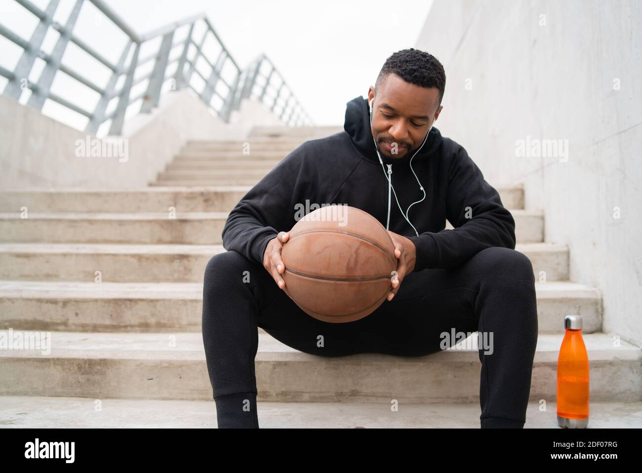 Athletic man holding a basket ball. Stock Photo