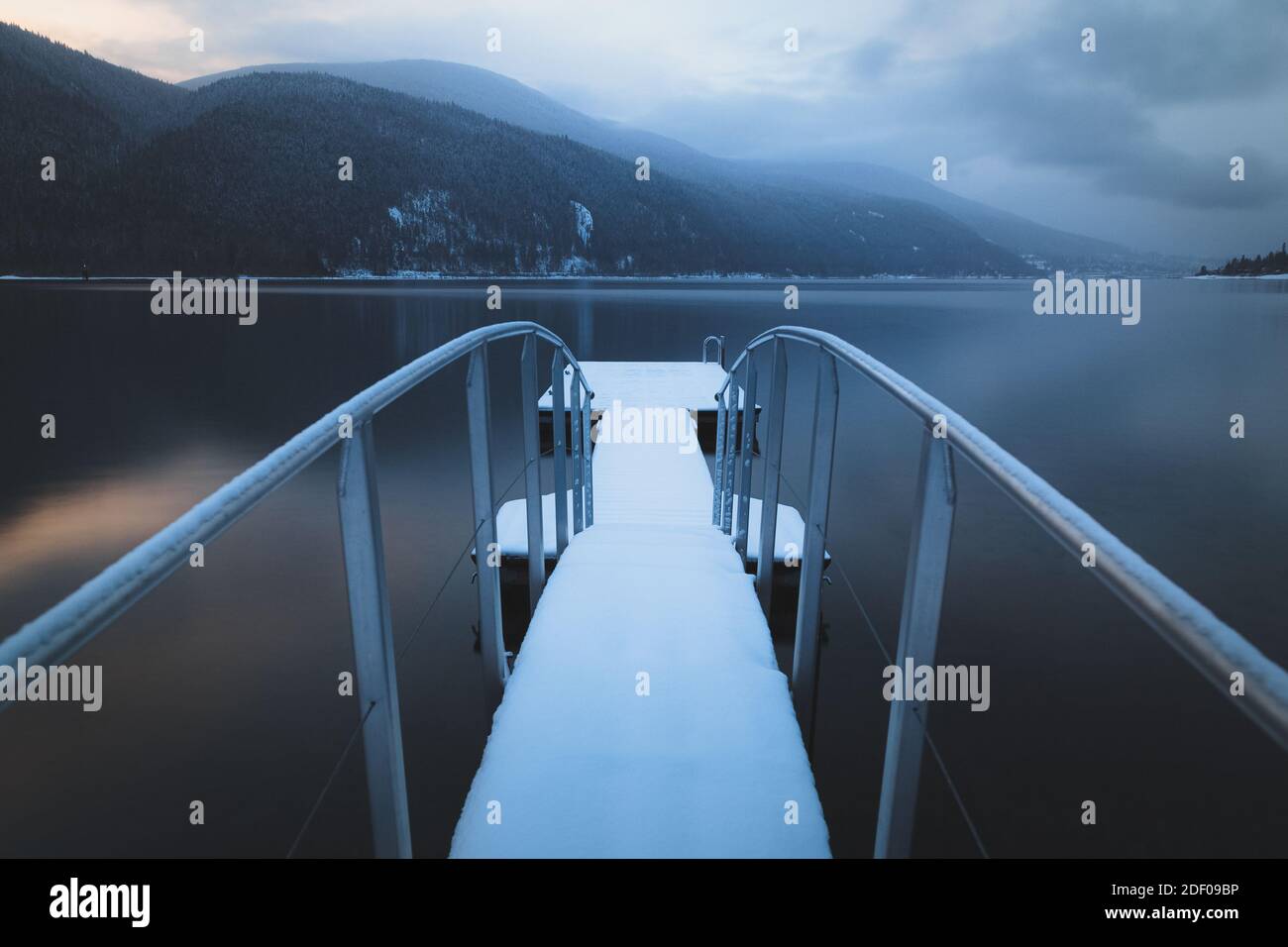 A snow covered jetty and dock on Kootenay Lake Stock Photo