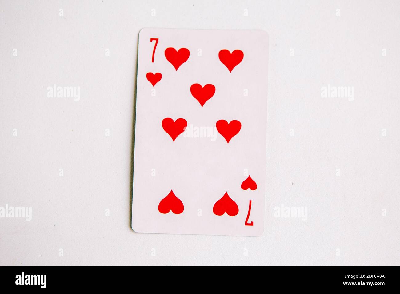 Seven of Hearts playing card, white background, top view Stock Photo