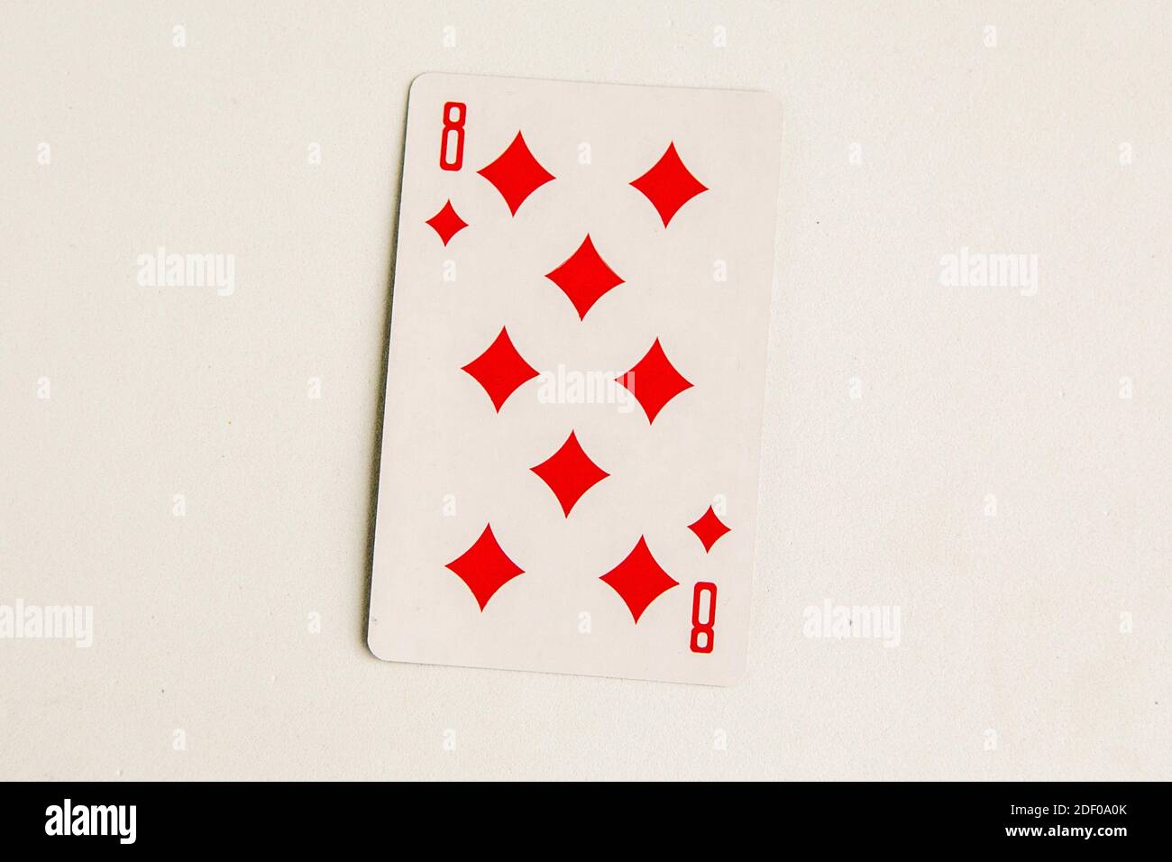 Eight of Diamonds playing card, white background, top view Stock Photo