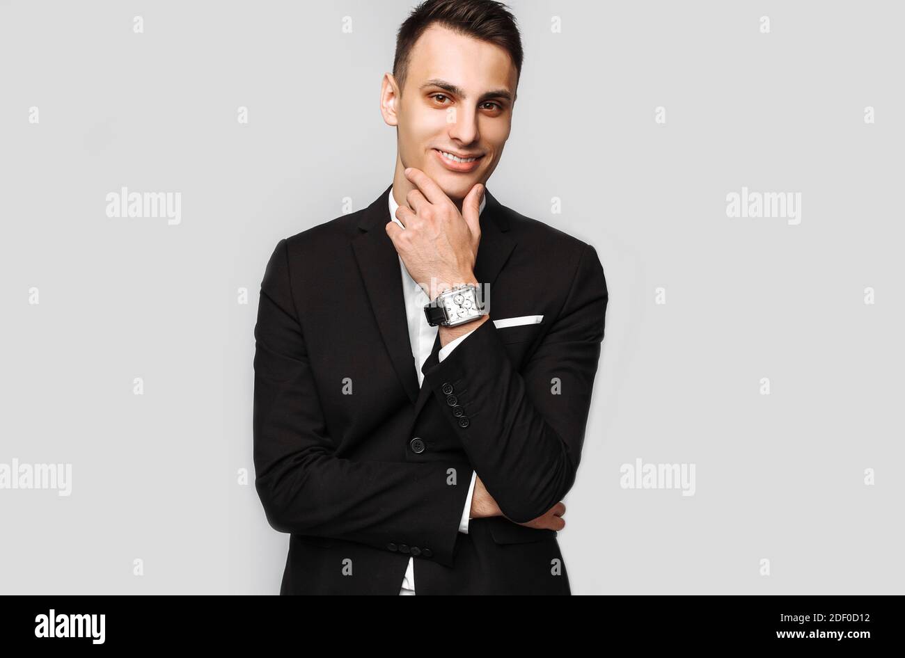 Portrait of a handsome young business man, male, in a classic black ...
