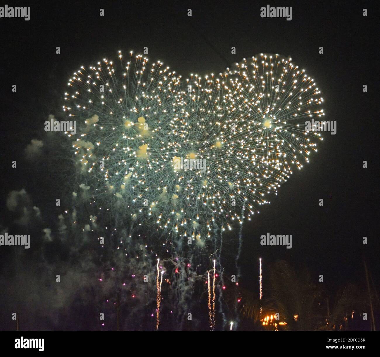 Firework  Bursts in Heart Shape against night Sky. Stock Photo