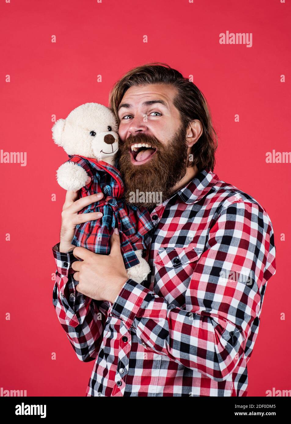 feel joy. cheerful bearded man hold teddy bear. male feel playful with bear. brutal mature hipster man play with toy. happy birthday. being in good mood. happy valentines day. Valentines day sales. Stock Photo