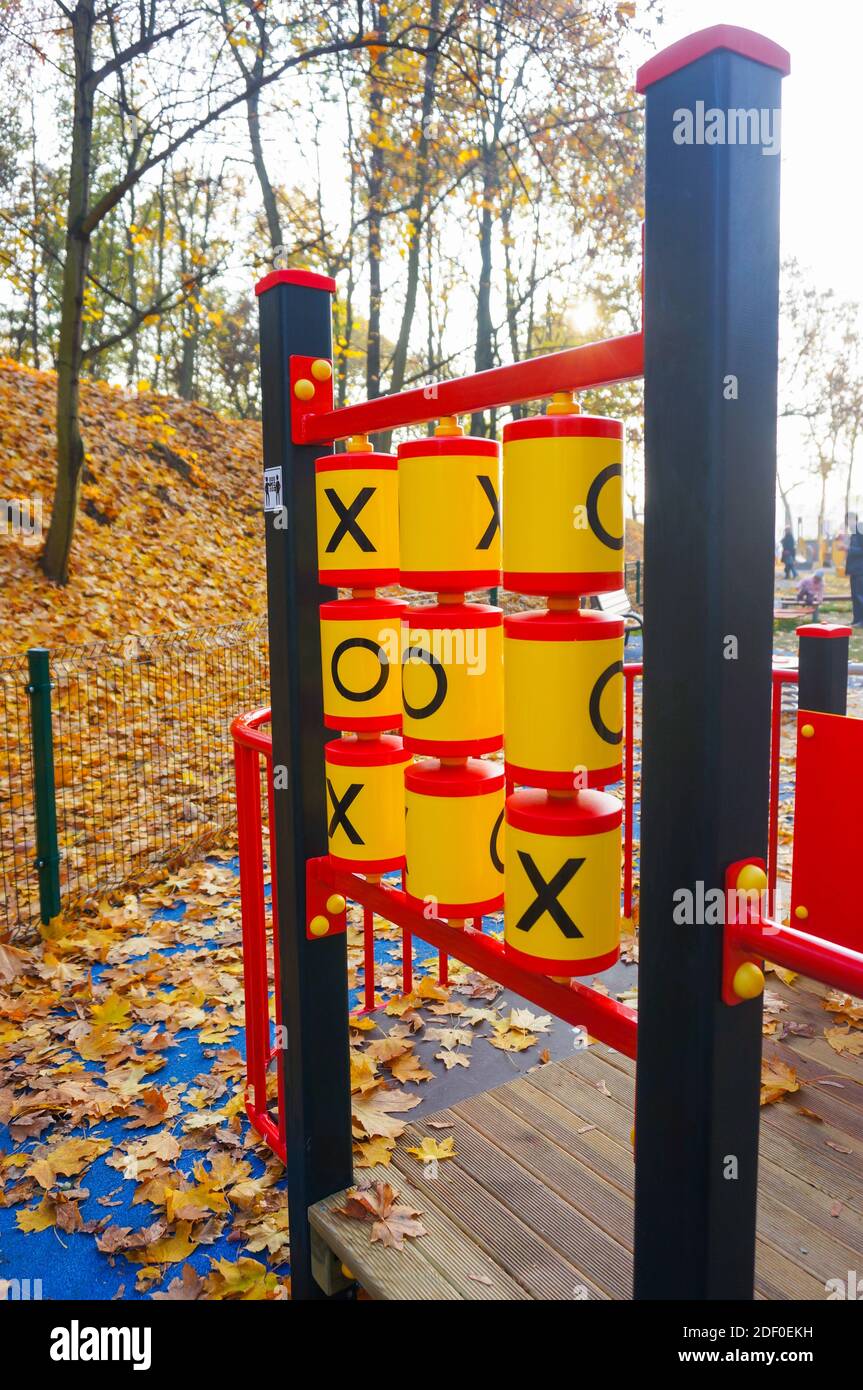 The colorful plastic tic tac toe XO game at the playground with leaves