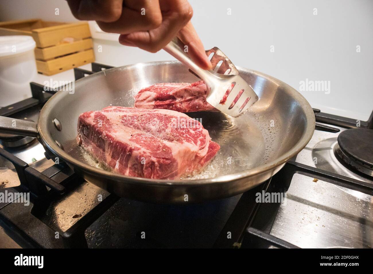 Ribeye Beef Steak In A Stainless Steel Pan With Butter Stock Photo Alamy