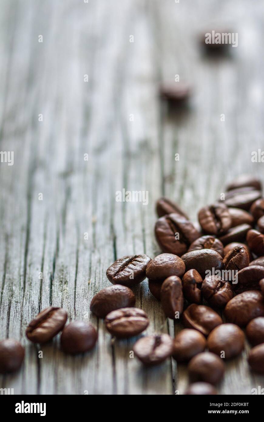 some coffee beans at old gray wood, vertical frame Stock Photo