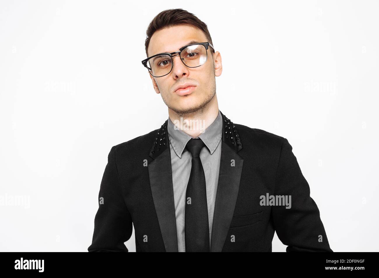 Portrait of a successful man in glasses and a black suit, a businessman posing on a white background Stock Photo