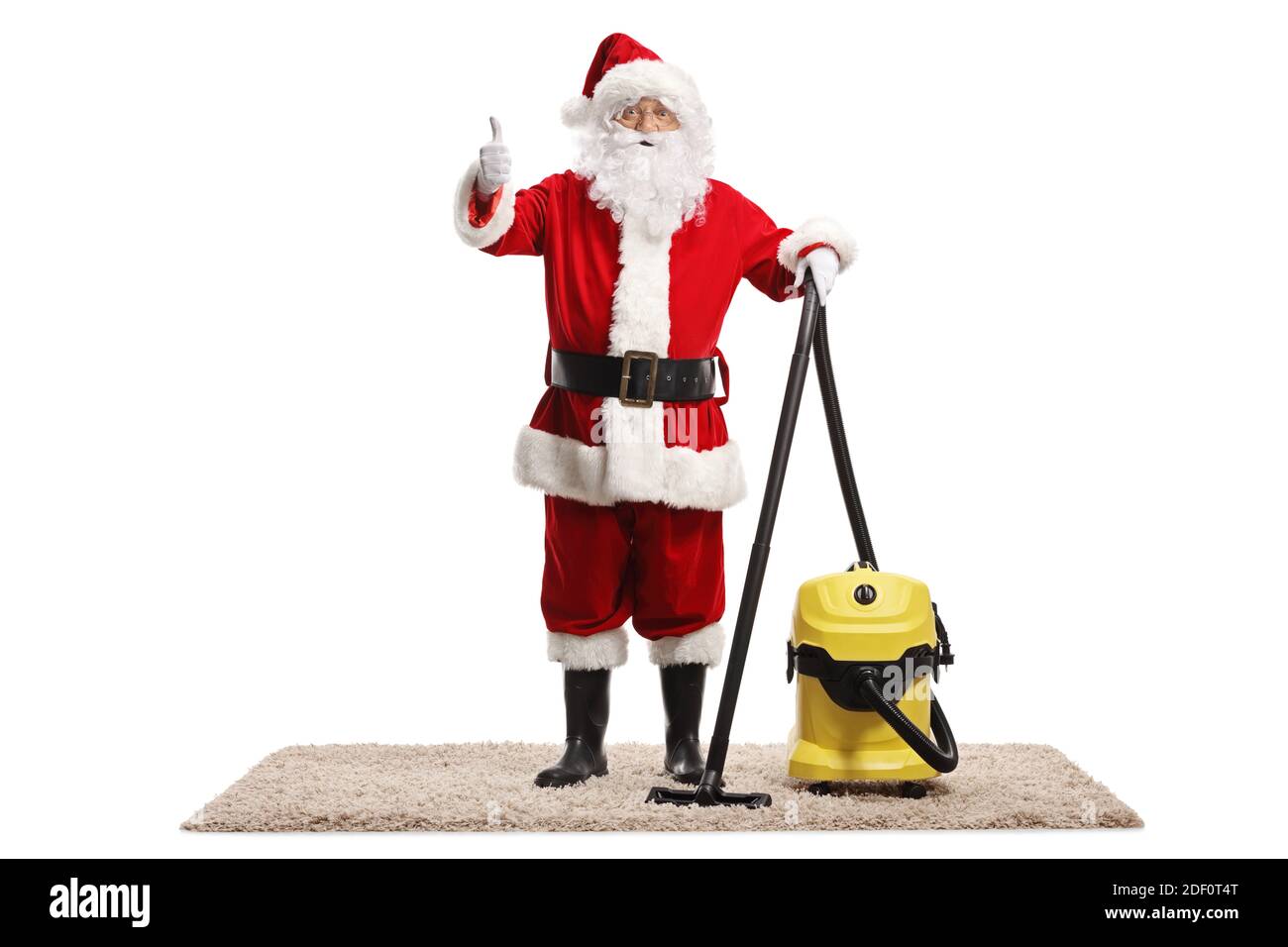 Santa claus with a vacuum cleaner on a carpet showing thumbs up