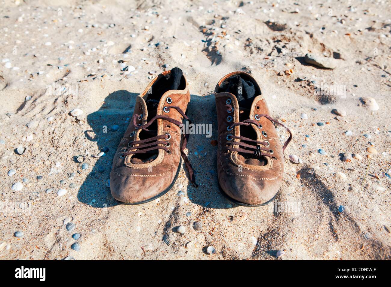 Old leather shoes on the beach . Socks inside shoes Stock Photo Alamy