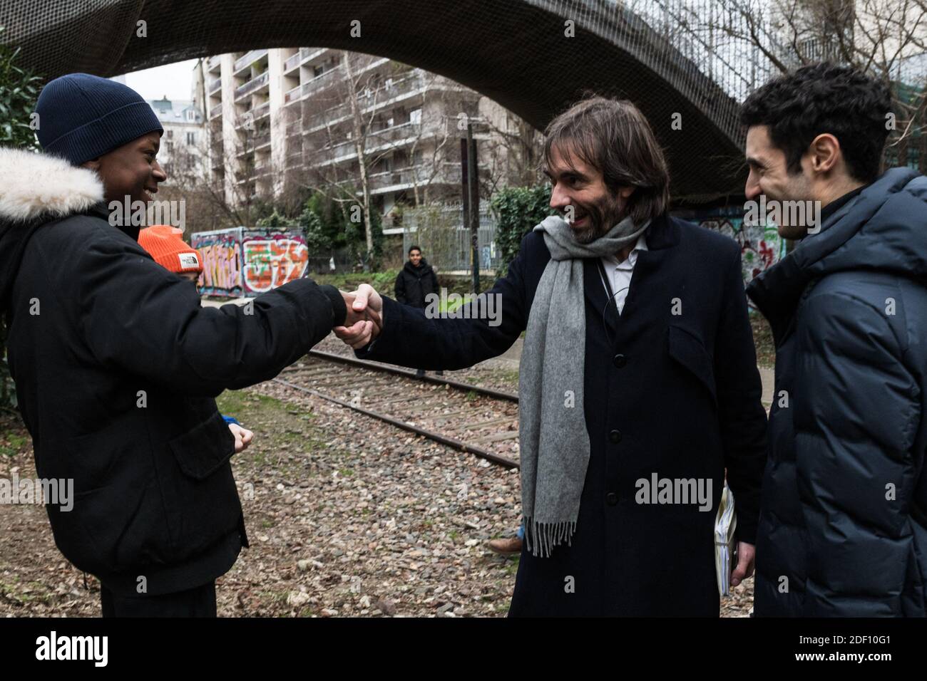 La Republique En Marche (LREM) MP and rebel mayoral candidate Cedric  Villani and Rayan Nezzar (R), candidate for the 20th District of Paris,  talk to young boys from the neighbourhood during his