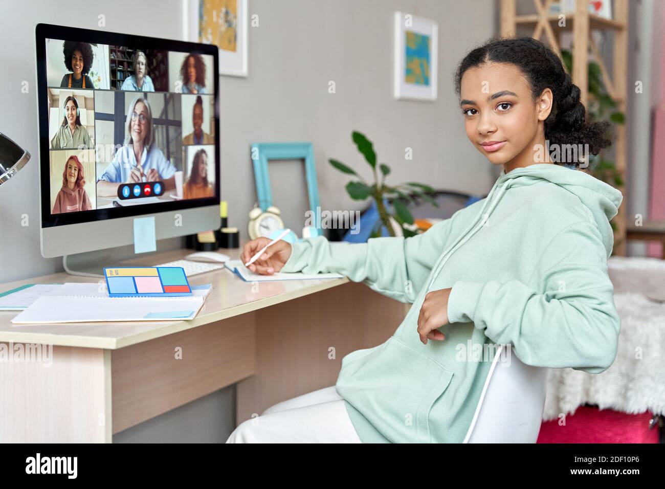 Teen african girl school student learn online class at home looking at camera. Stock Photo