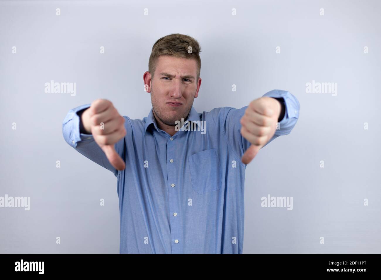 Business young man wearing a casual shirt over white background doing ...