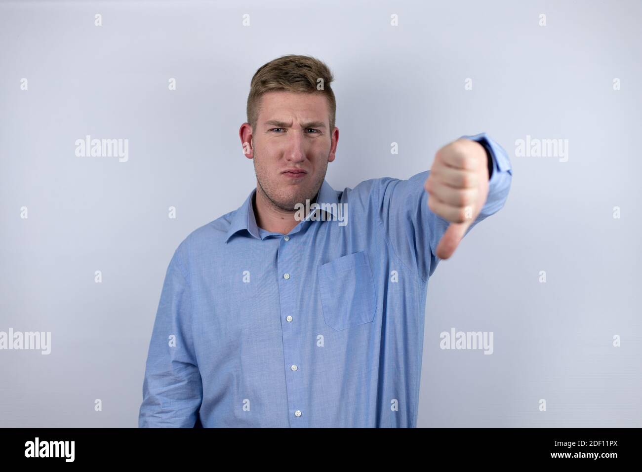 Business young man wearing a casual shirt over white background doing ...