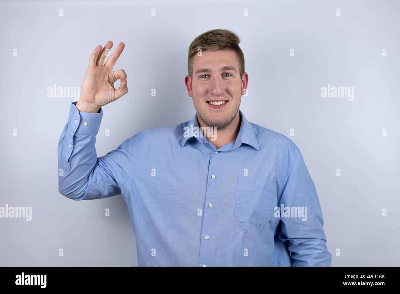 Business young man wearing a casual shirt over white background doing ...