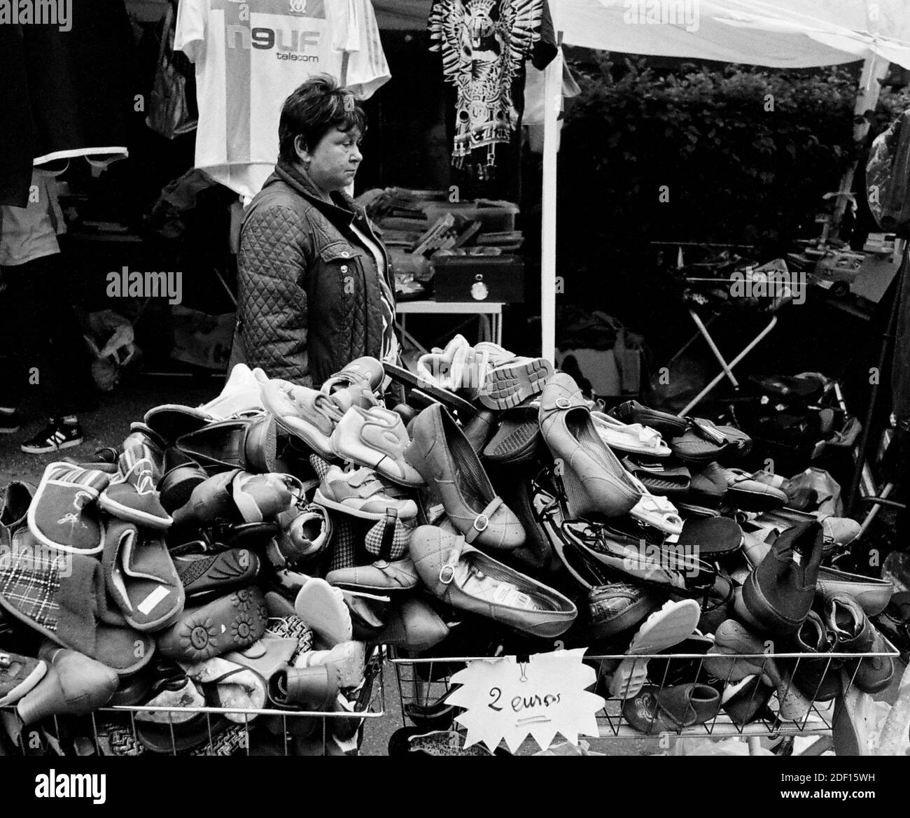 AJAXNETPHOTO.  LOUVECIENNES, FRANCE. - ATTIC CLEAROUT - STALL HOLDER AT THE ANNUAL 'VIDE GRENIERS' SELLING SHOES;THE VILLAGE WAS A LOCATION FREQUENTED BY 19TH CENTURY ARTISTS INCLUDING CAMILLE PISSARRO AND ALFRED SISLEY. RENOIR LIVED THERE FOR A WHILE.PHOTO:JONATHAN EASTLAND/AJAX REF:CD1541 2 Stock Photo