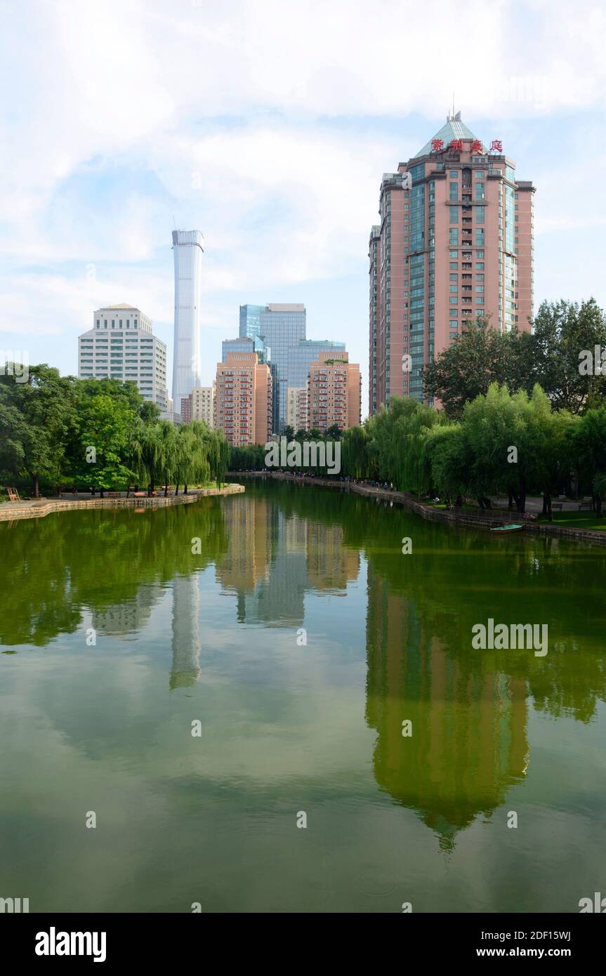 View across the lake in Tuanjiehu park with the China Zun skyscraper in the distance. Beijing, China Stock Photo