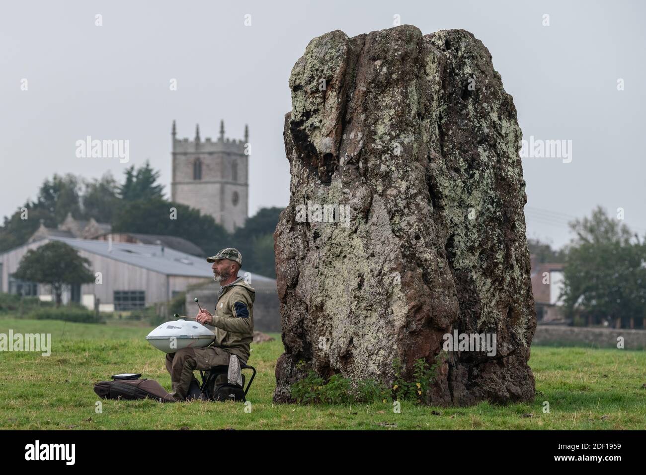 Autumn Equinox at Stanton Drew Stone Circle. A man plays a handpan drum or ‘Hang’ during the final morning before summer officially ends. Somerset, UK Stock Photo