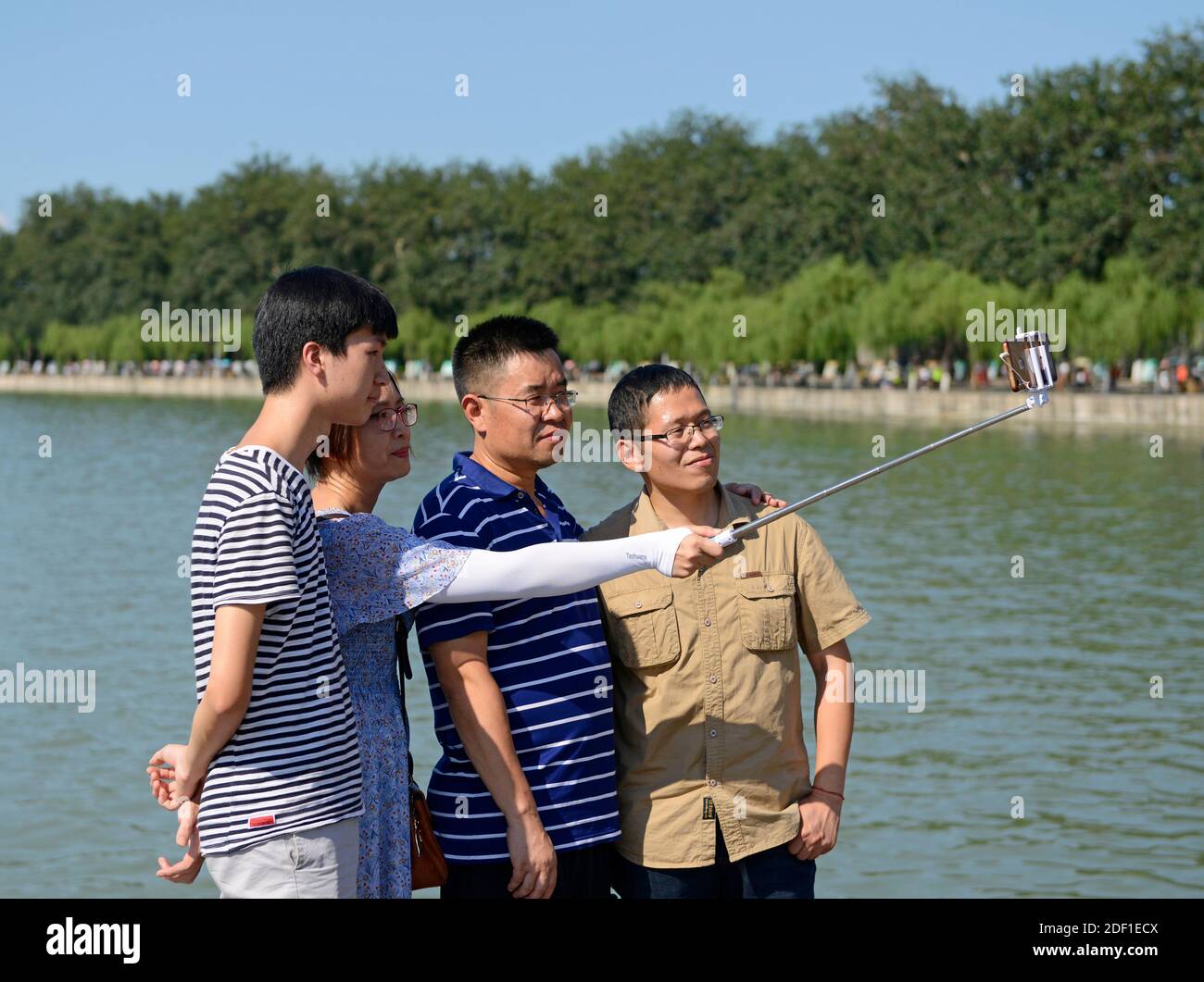 A group of friends take a selfie on Nanhu island at the western end of the seventeen arch bridge in the Summer Palace compound in Beijing, China Stock Photo