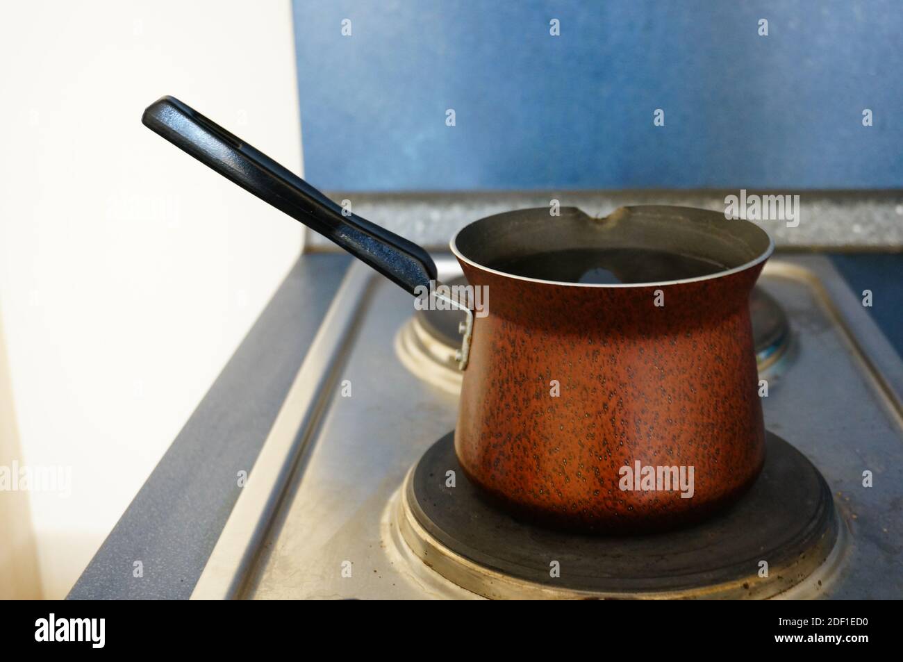 An closeup of an old copper pot with a spout on a stove Stock Photo Alamy