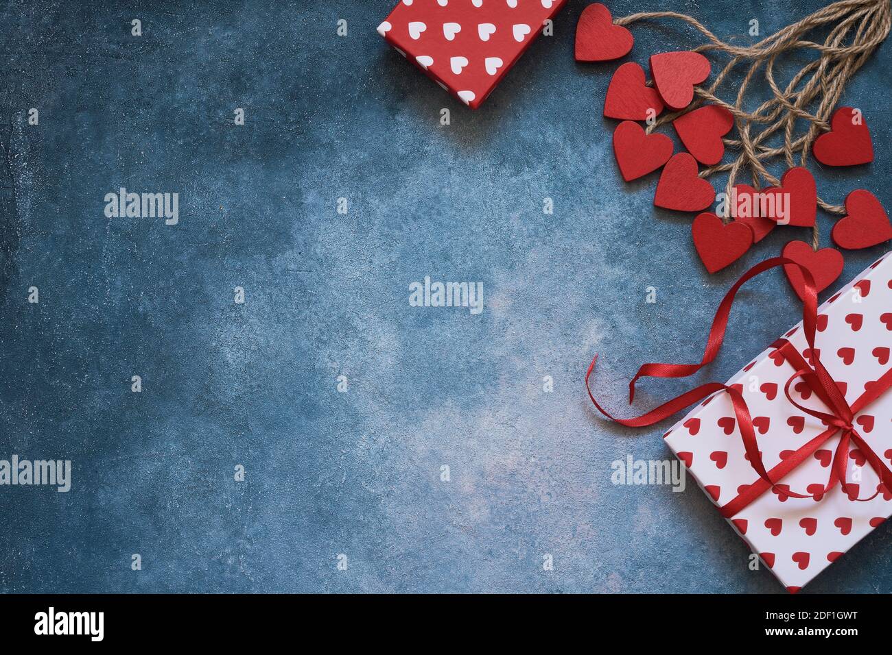 Valentines Day background. Red hearts and gift boxes on blue background ...