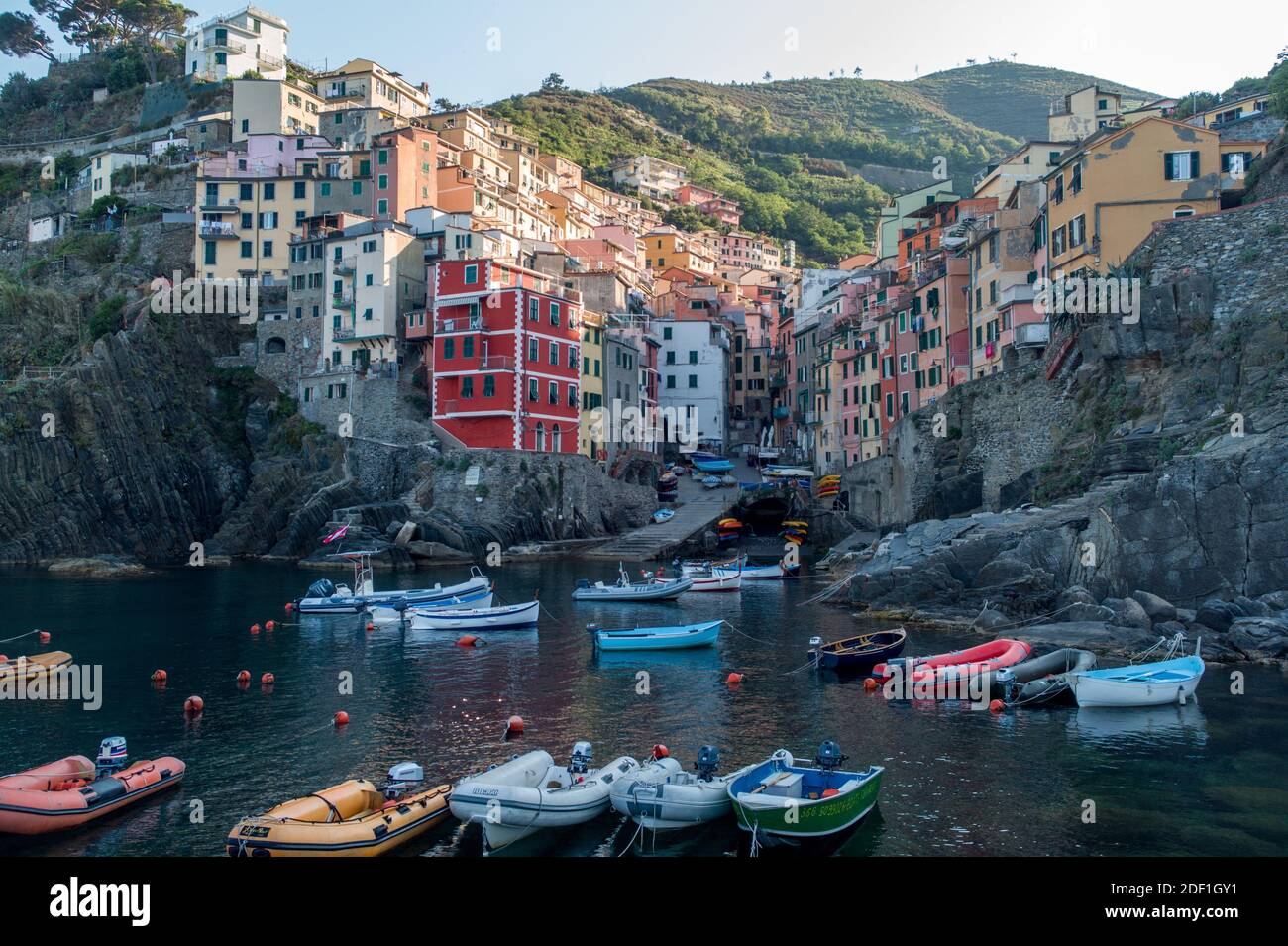 Colorful Riomaggiore village from the sea at sunrise, Cinque Terre Stock Photo