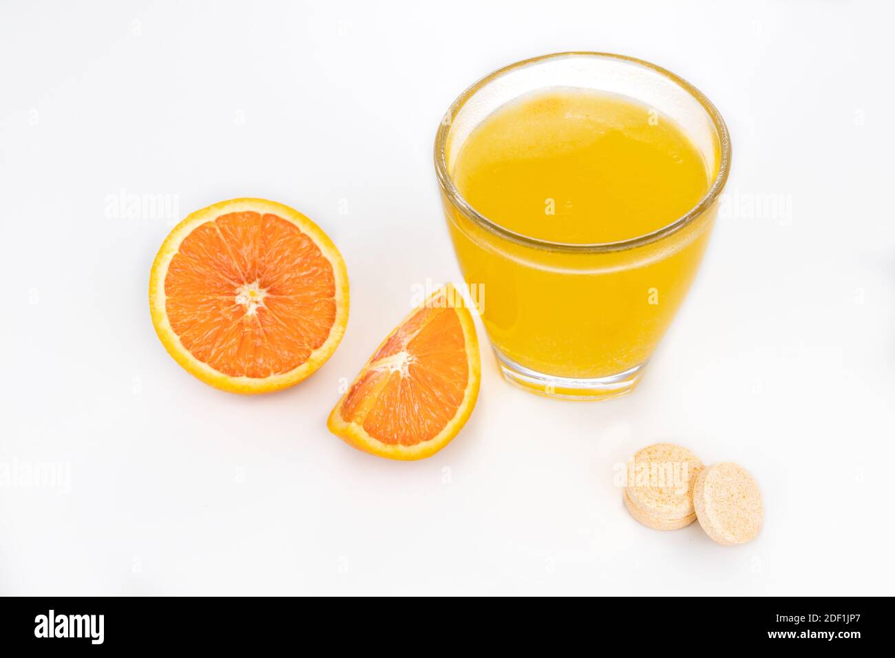 Orange flavored vitamin c effervescent tablet dissolve in glass of water Stock Photo