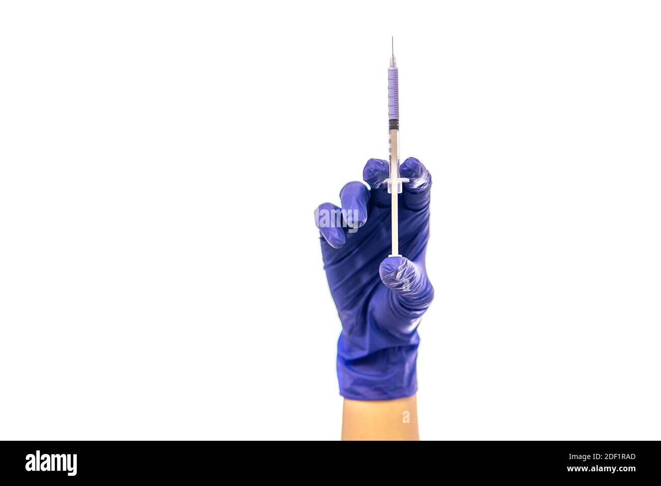 hand in medical glove holds a syringe. isolated on white. high quality Stock Photo