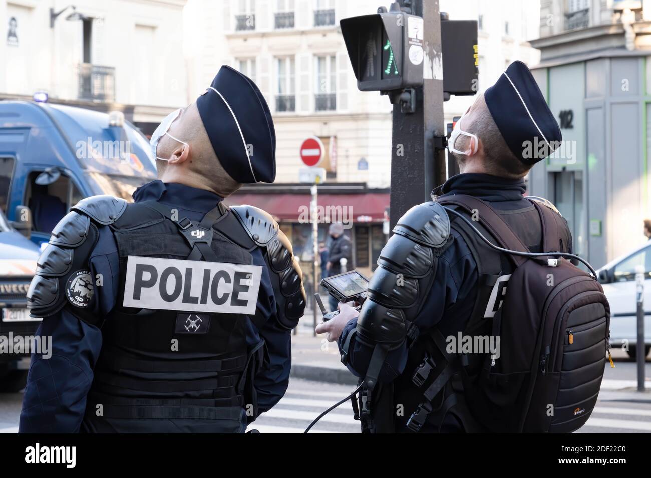 Paris, France - November 28th 2020 : at the march against the global security law, police officers operating a drone Stock Photo