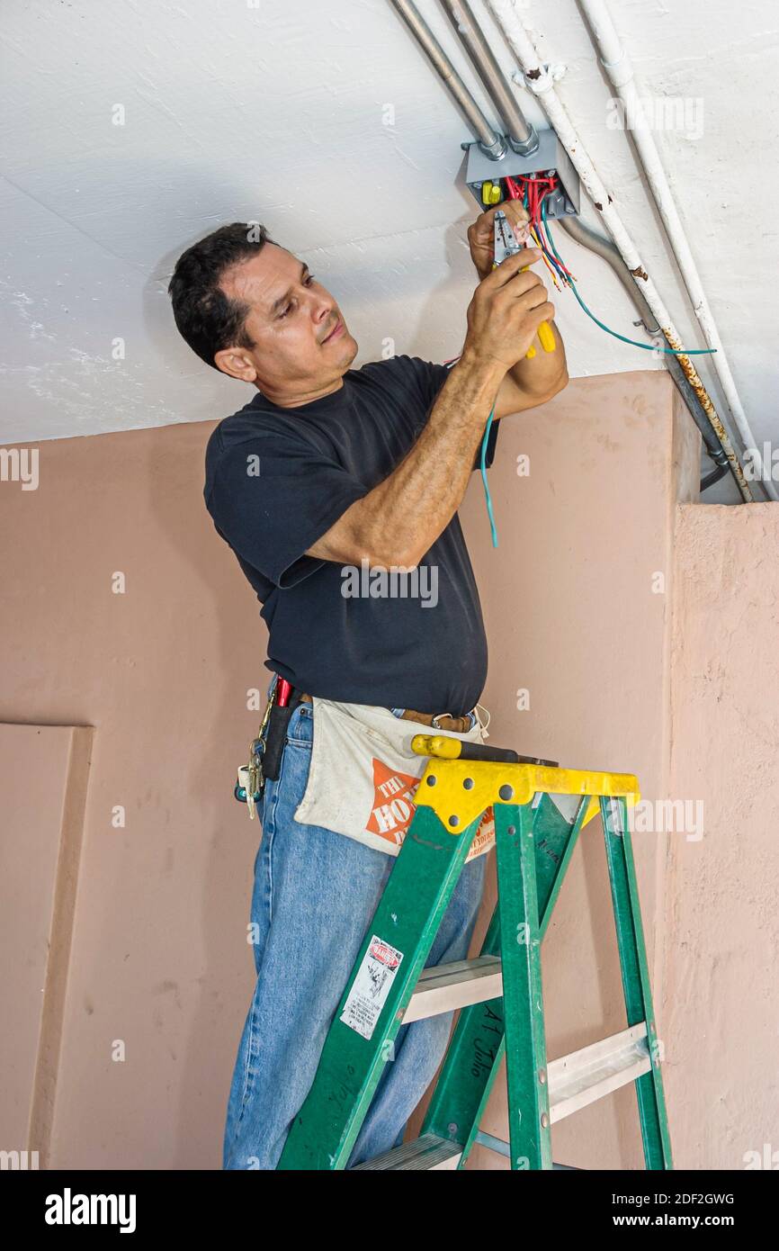 Miami Beach Florida,Hispanic man male,installing installs condominium