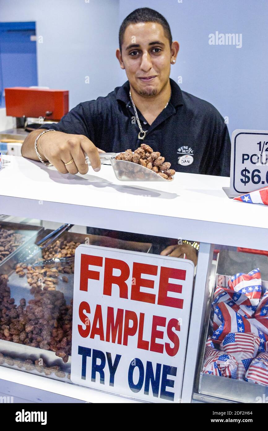 Miami Beach Florida,Miami Beach Convention Center,centre,taste try free sample nuts vendor Asian man offers offering, Stock Photo