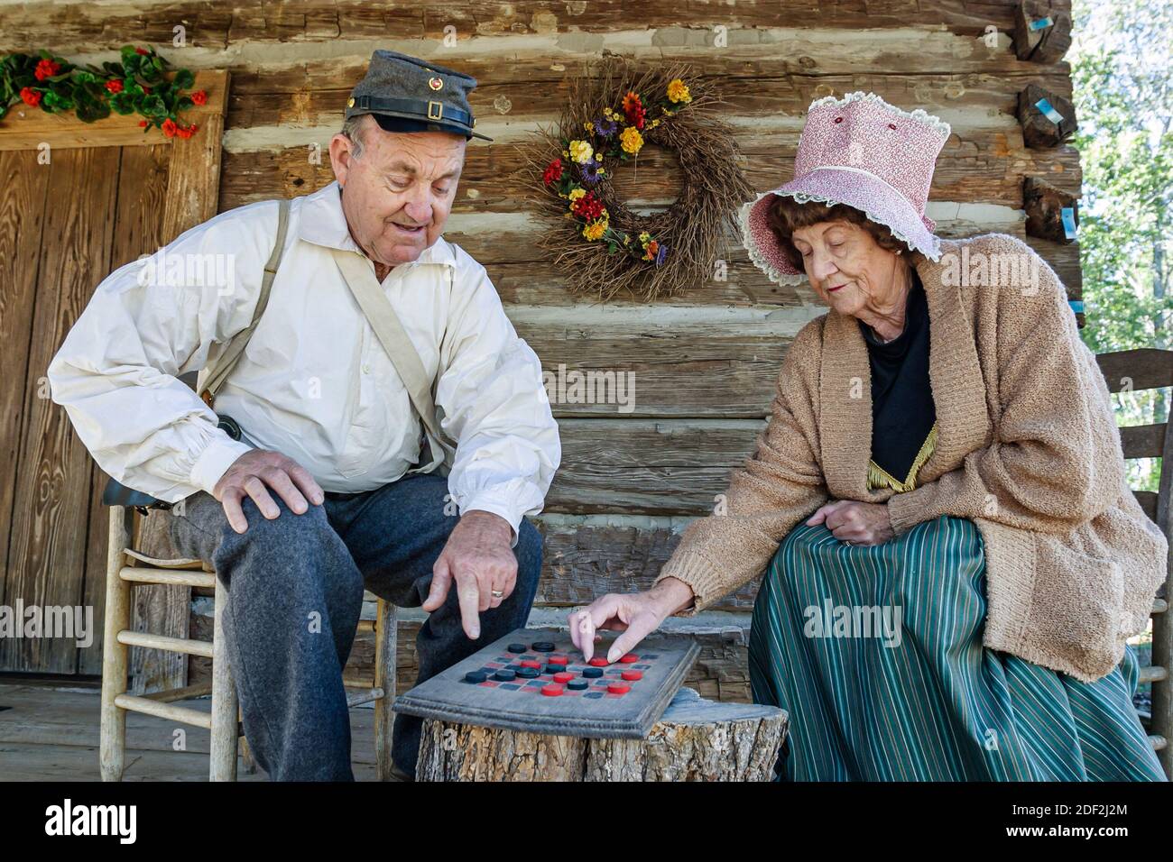 Alabama Leighton LaGrange College Site Park mountain town replica,historic village reenactors guides wearing period costumes,play playing checkers, Stock Photo