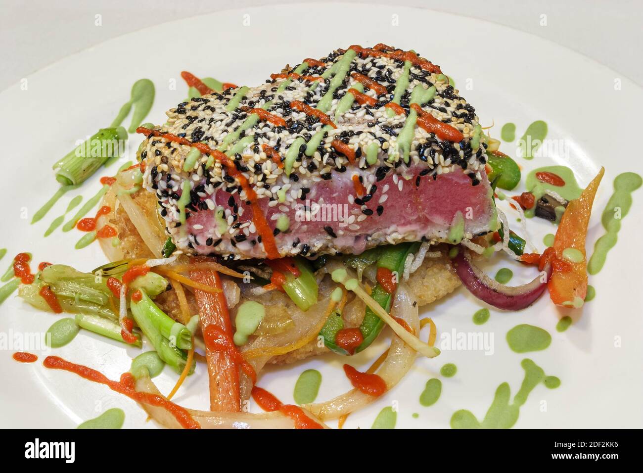 Huntsville Alabama,Jazz Factory restaurant,rare seared tuna over fried sushi rice cake,Asian vegetables wasabi glaze,food plate display, Stock Photo