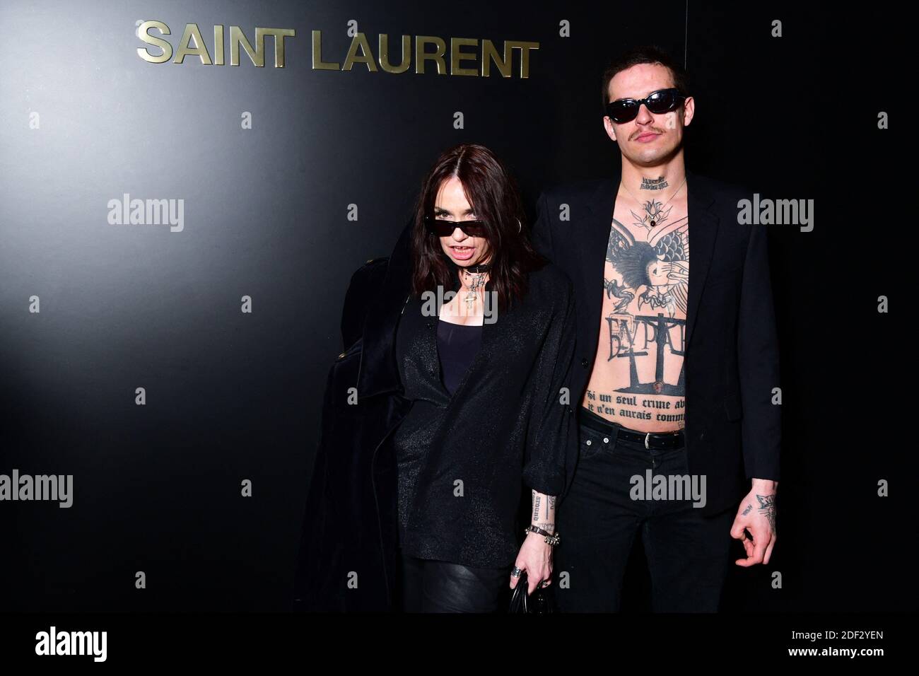 Beatrice Dalle and Paul Bichet attend the Saint Laurent show as