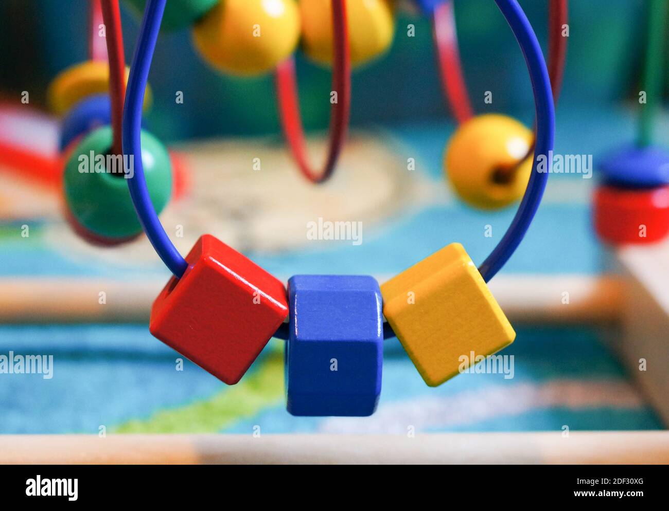 A wooden toy with different colorful shapes for kids Stock Photo - Alamy